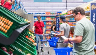 Three white men shopping in a supermarket