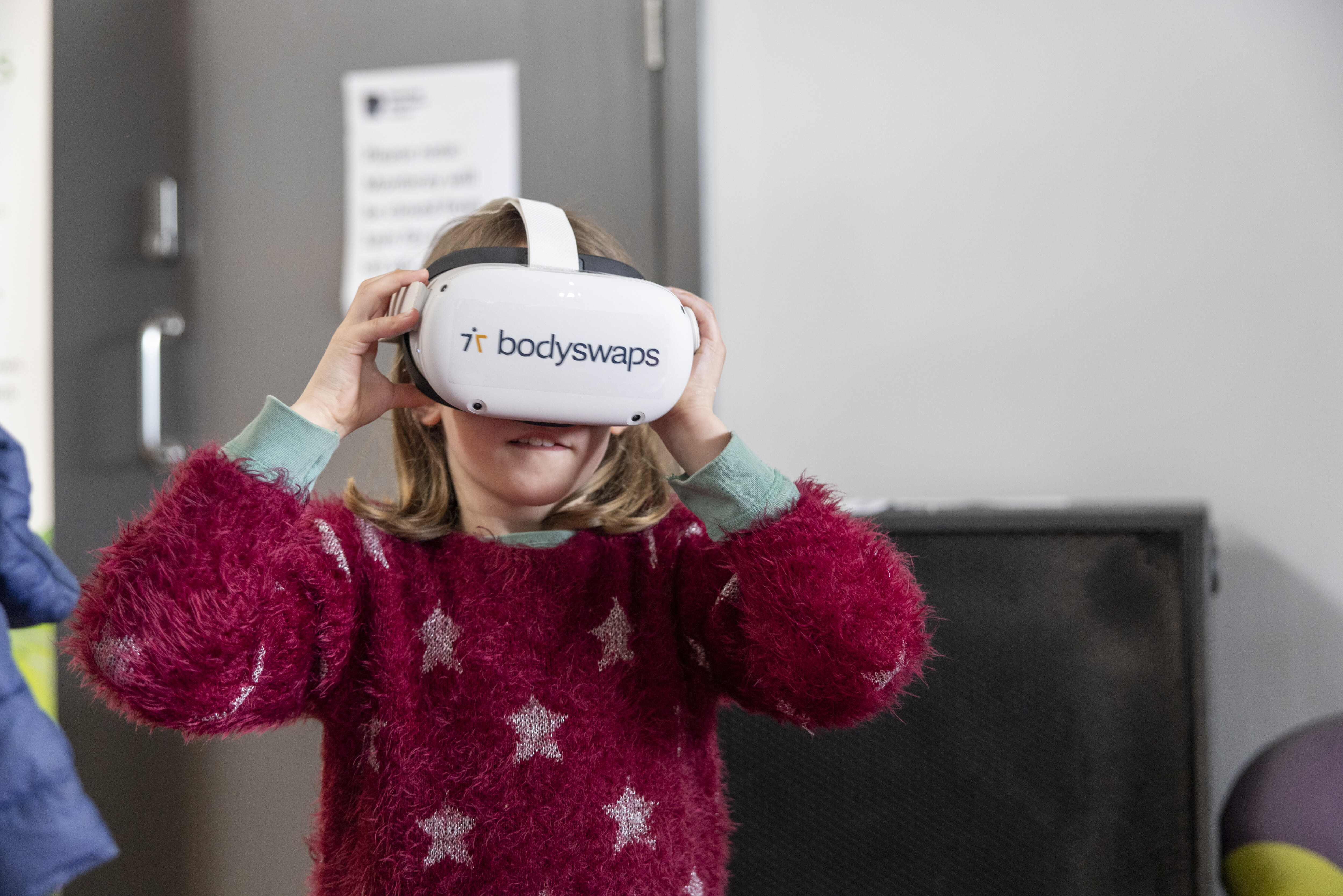 A young girl wearing a virtual reality headset