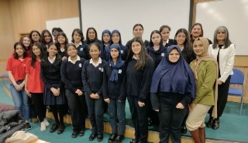 A group of South-Asian female students from Reading Girls' School and Eden Girls' School with speakers from the event