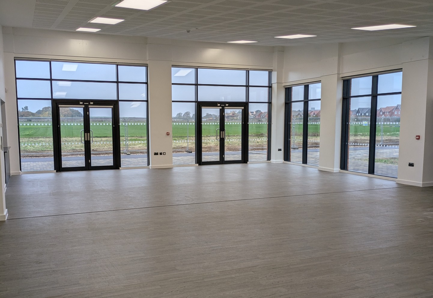 Image of a large empty function room overlooking green space