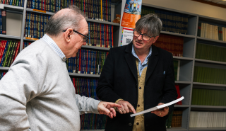 Simon Armitage being presented Stephen Burt's weather book