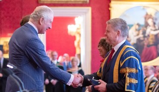 His Majesty King Charles III, then Prince Charles, (L) presenting the Queen's Anniversary Prize to Professor Robert Van de Noort, Vice-Chancellor of the University of Reading (R) on 17 February 2022