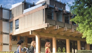 The north side of the URS building with a campus tour going on in the foreground