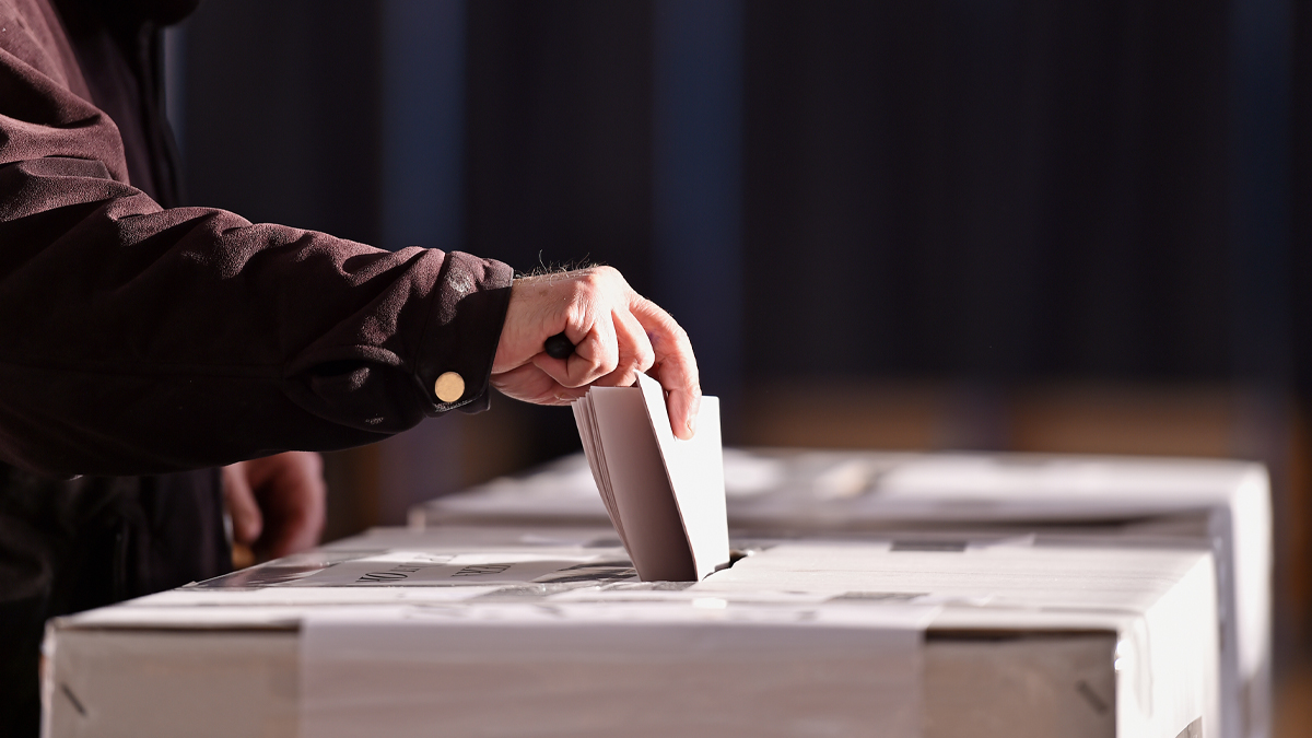 vote being placed into a ballot
