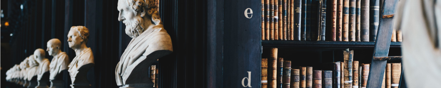 A row of historical statues in a library
