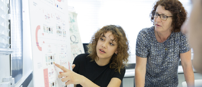 A student presents to her lecturer.