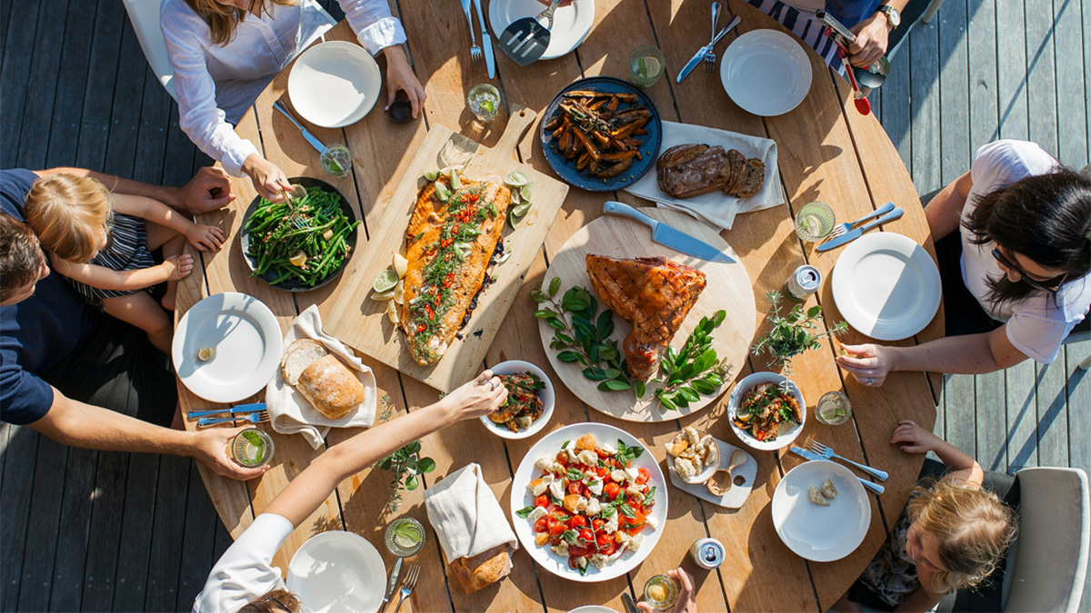 People sat around a table with a meal on it