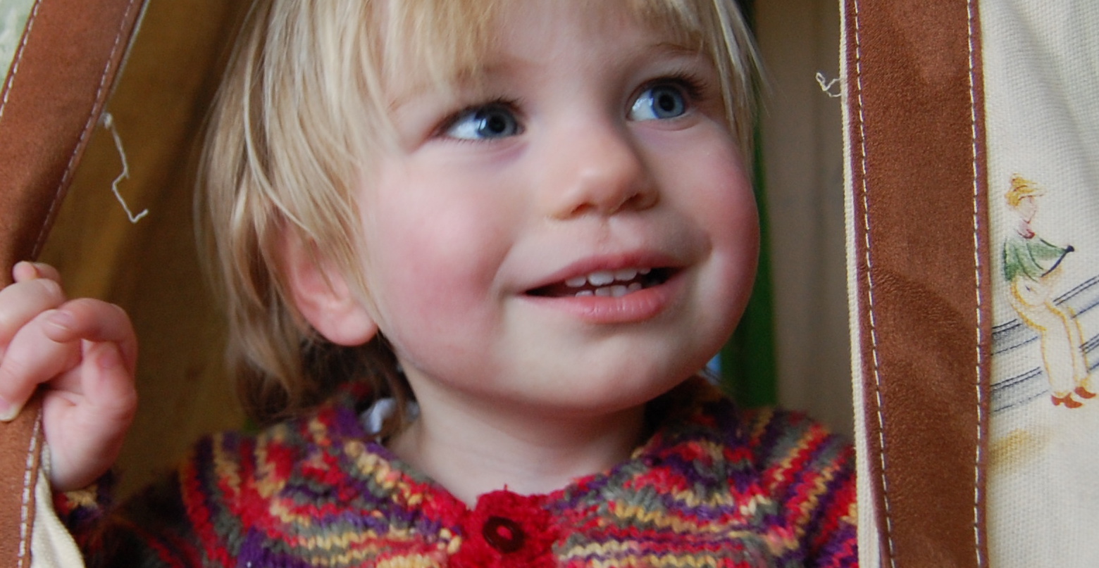 A child peeking out of a tent