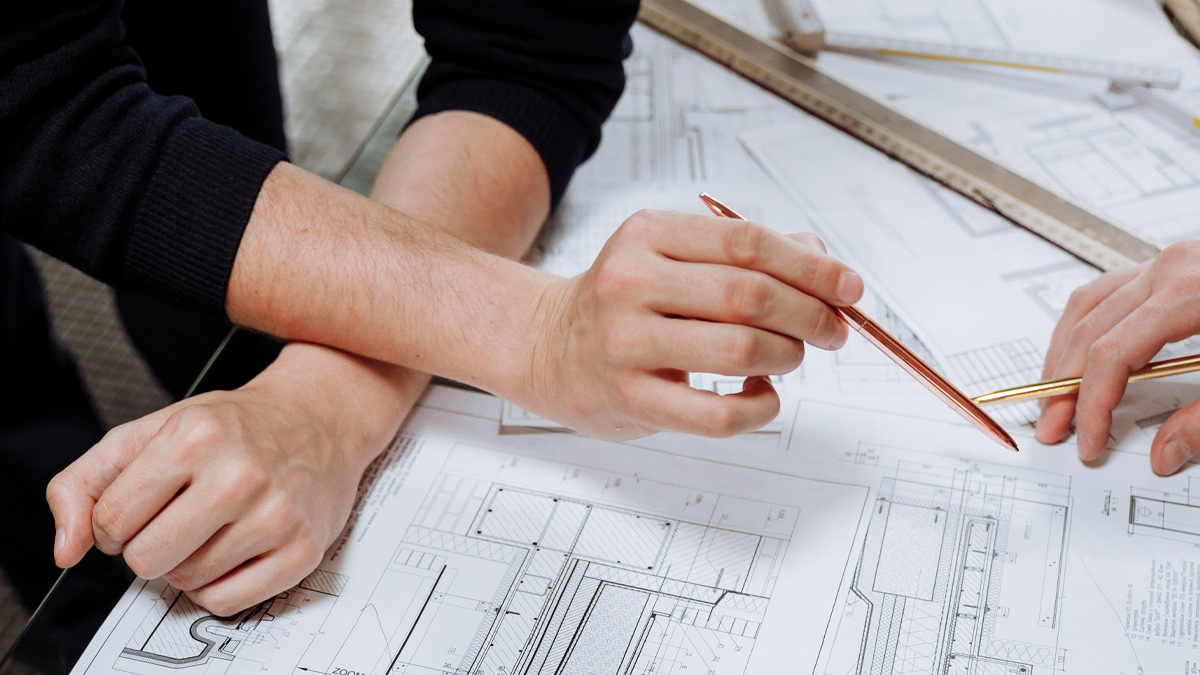 Two people reviewing architectural plans