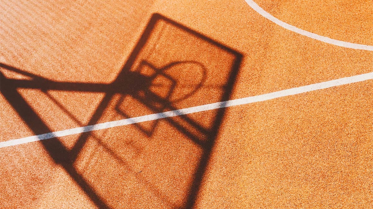 Shadow of hoop on basketball court