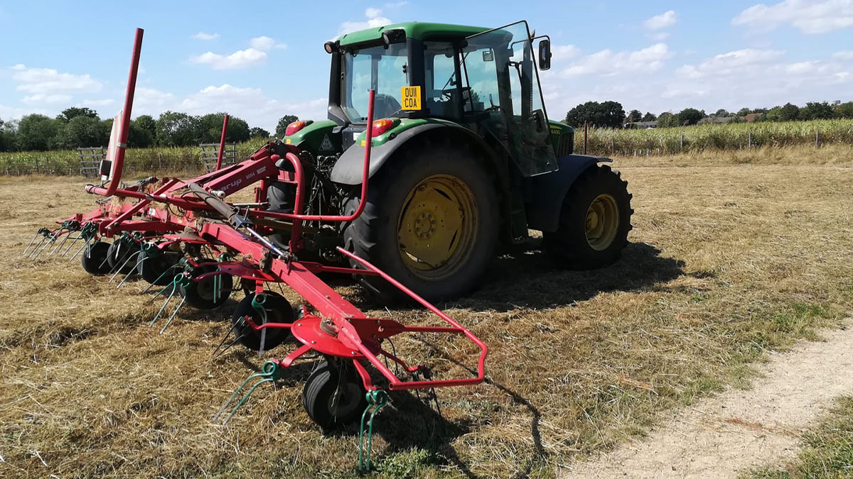 Tractor gathering hay