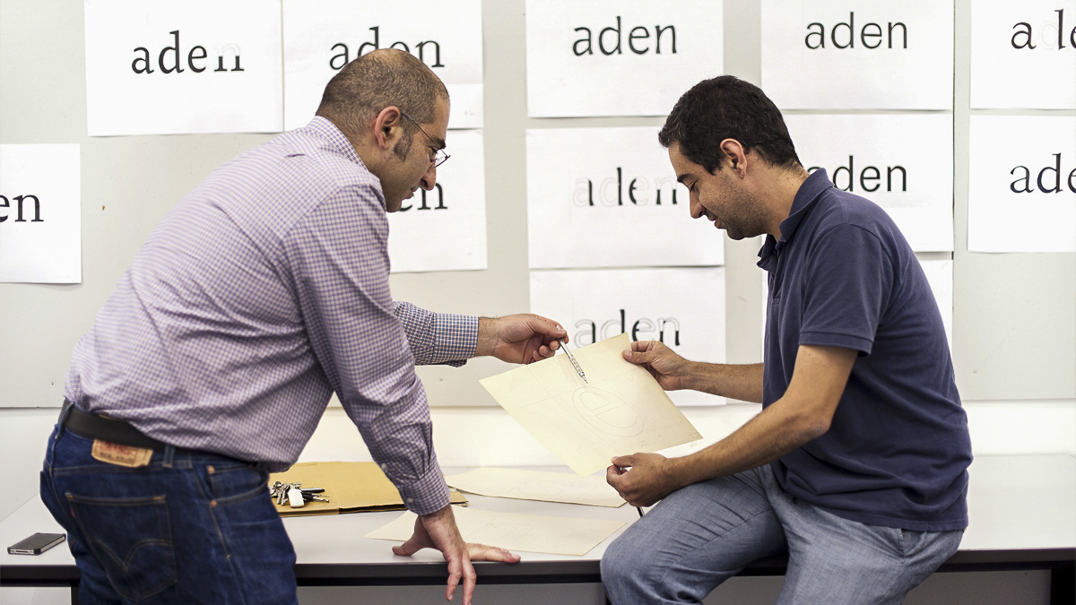 Professor Gerry Leonidas discussing typeface design with a student on Type Design intensive course
